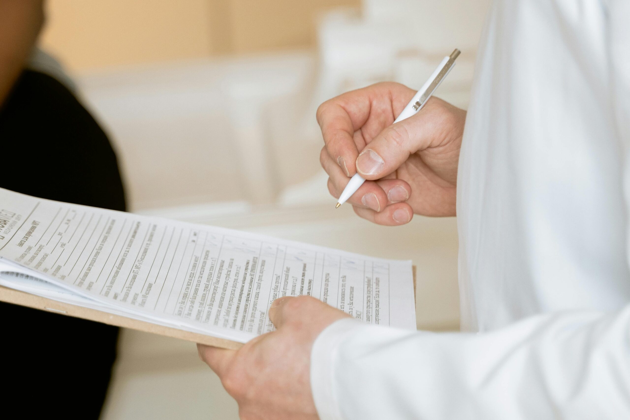 Photo-Of-Person-Holding-Paper-And-Pen