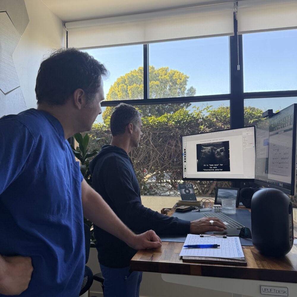 physicians look at patient scans