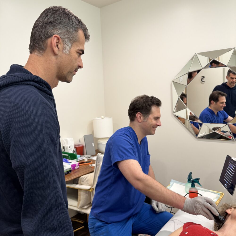 physician ultrasounds a patient's neck